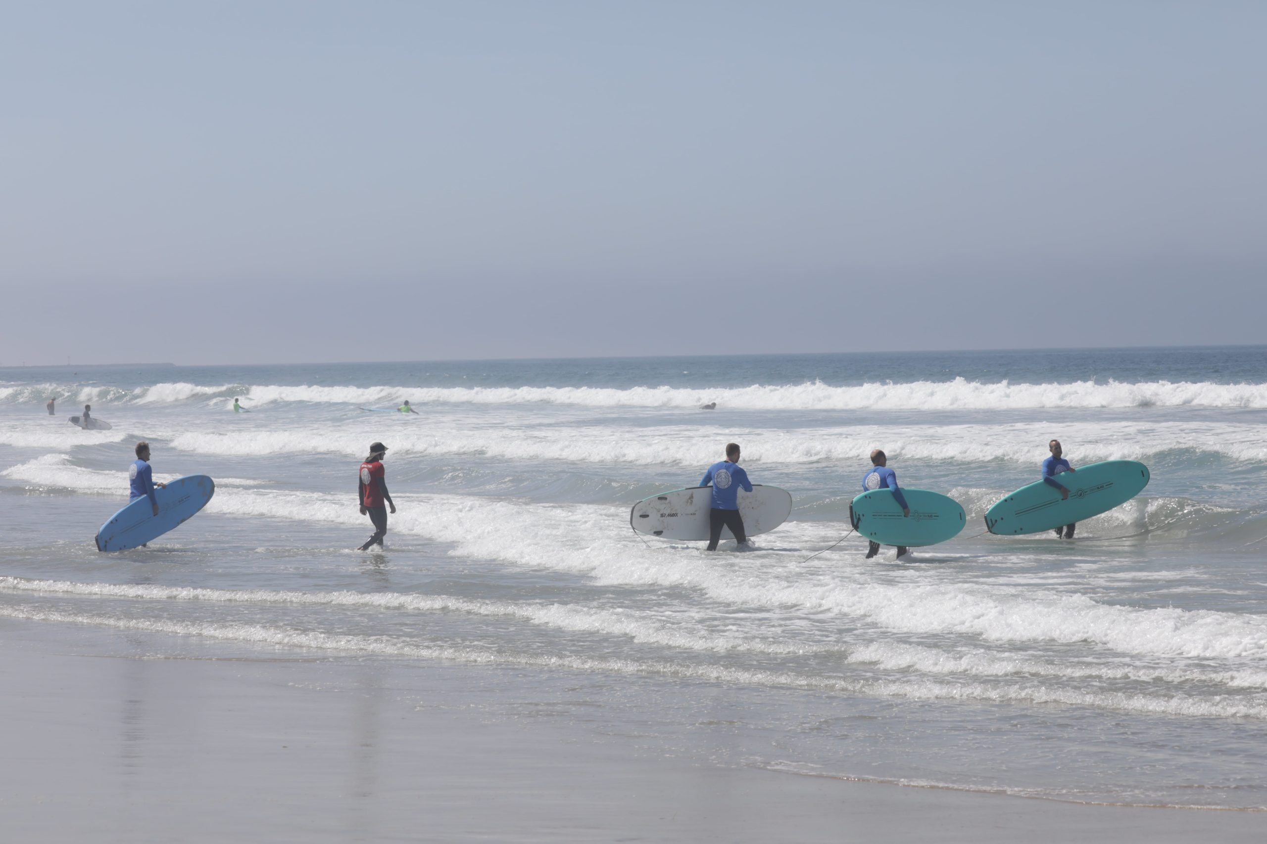 SpinupWP team surfing in the ocean